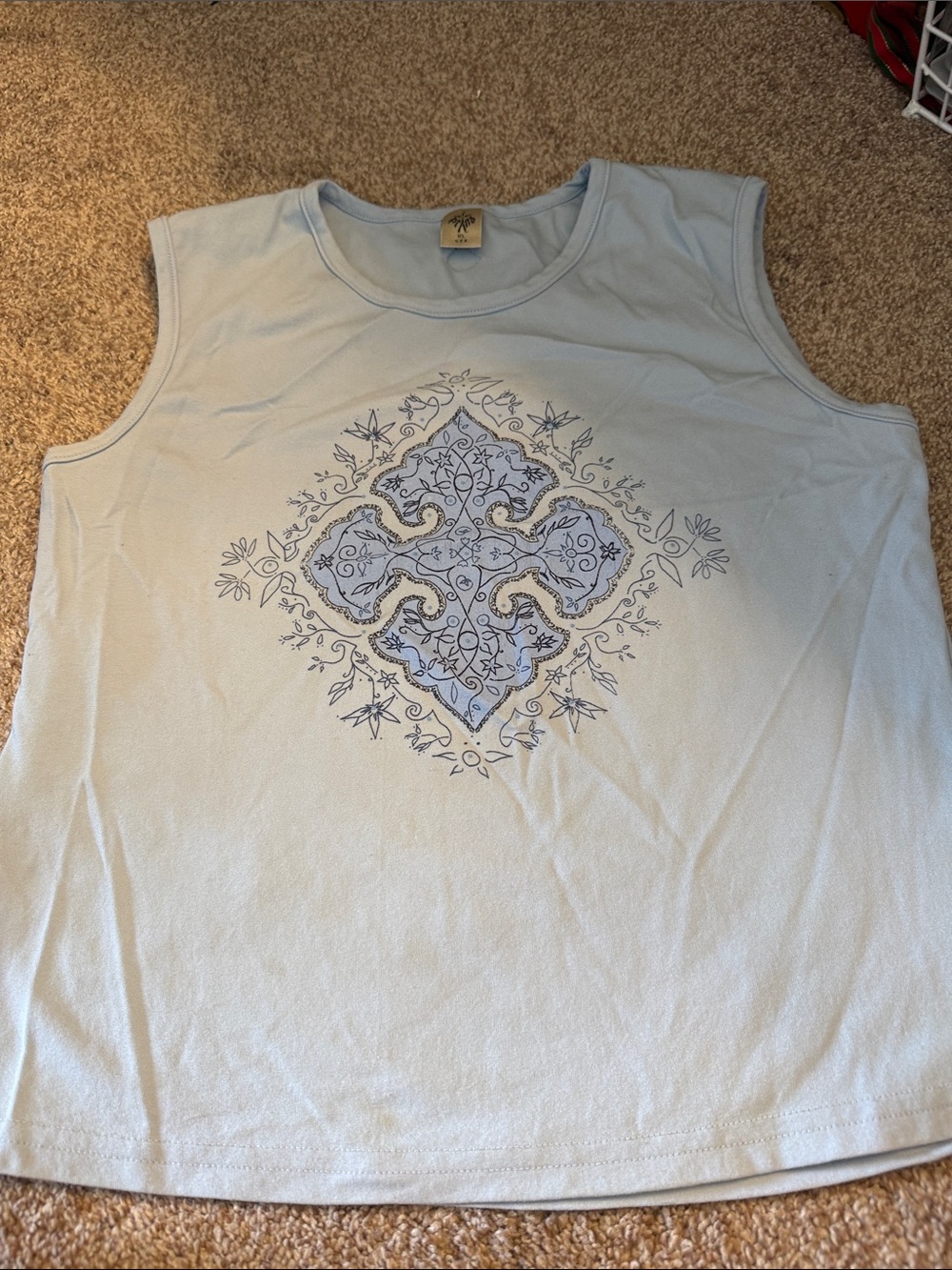 Light Blue Sleeveless women ‘s Shirt with Decorative Medallion
